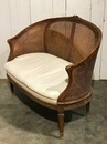 style Louis XVI rounded caned sofa