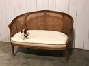 style Louis XVI rounded caned sofa