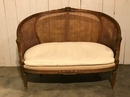 style Louis XVI rounded caned sofa