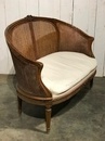 style Louis XVI rounded caned sofa