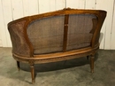 style Louis XVI rounded caned sofa